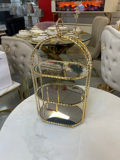Estantería decorativa cilíndrica dorada con espejo interior