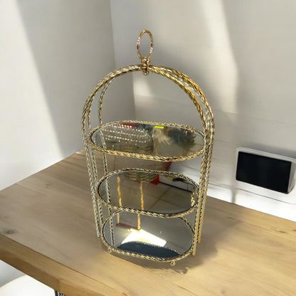 Estantería decorativa cilíndrica dorada con espejo interior