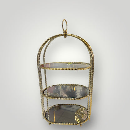 Estantería decorativa cilíndrica dorada con espejo interior