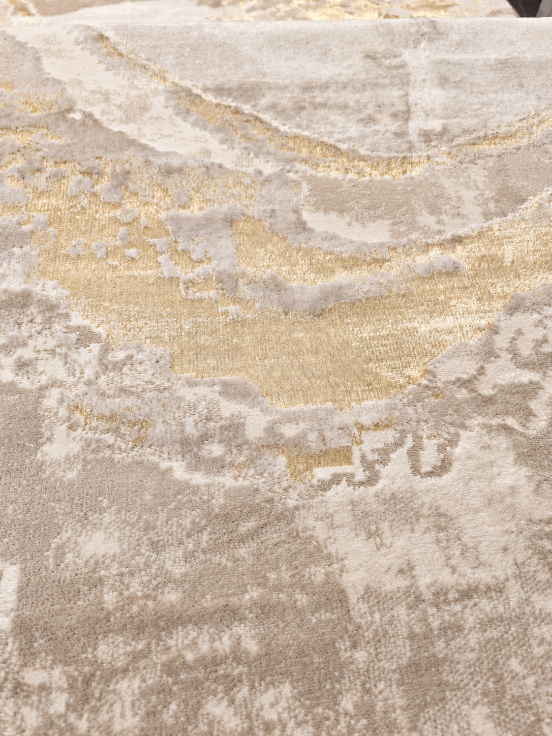 Áurea Beige / Dorado: detalle de la textura con iluminación retocada digitalmente.