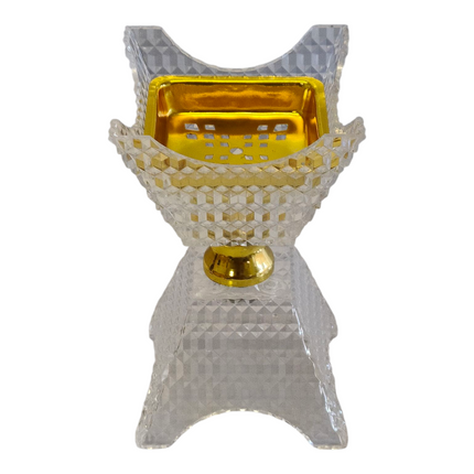 Incensário árabe transparente e dourado com design em cristal esculpido.